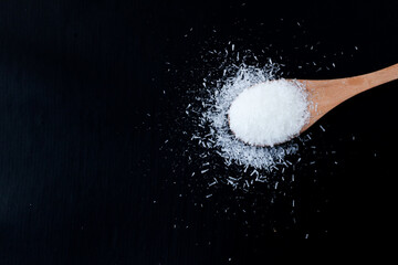 Wooden Spoon of MSG Seasoning on Black Background