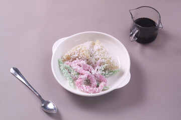 Indonesian traditional dessert,Cenil and Lopis. Cenil is steamed sweet tapioca flour. Lopis is Sweet Cake Made of Glutinous Rice. served with palm sugar and coconut grated.
