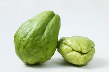 Fresh Chayotes: A Close-Up Look at Two Vibrant Green Chayotes on a White Background
