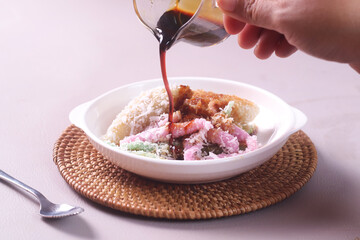 Indonesian traditional dessert,Cenil and Lopis. Cenil is steamed sweet tapioca flour. Lopis is Sweet Cake Made of Glutinous Rice. served with palm sugar and coconut grated.
