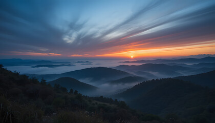 Sunrise over misty mountain ranges