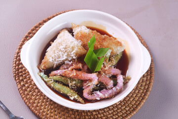 Indonesian traditional dessert,Cenil and Lopis. Cenil is steamed sweet tapioca flour. Lopis is Sweet Cake Made of Glutinous Rice. served with palm sugar and coconut grated.
