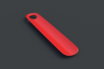 Red shoehorn on black background. Plastic shoe spoon. 3d render