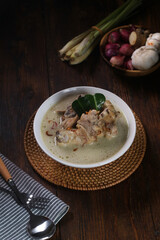 Opor Ayam, Indonesian traditional chicken curry,. made from chicken cooked with coconut milk and spices. Popular to celebrate Eid Fitr, serving with ketupat (rice cake) and sambal goreng
