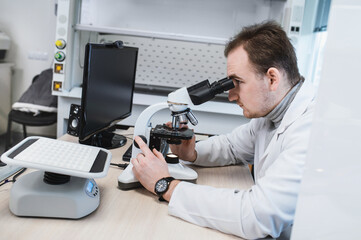 Professional scientist using microscope in laboratory setting. Modern science and medicine...