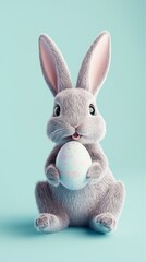 Obraz premium A cute bunny with soft fur holds a beautifully decorated pastel egg, sitting against a light blue background. This charming scene captures the essence of Easter festivities and joy