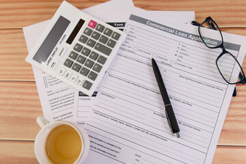 Commercial loan application paperwork and calculator setup