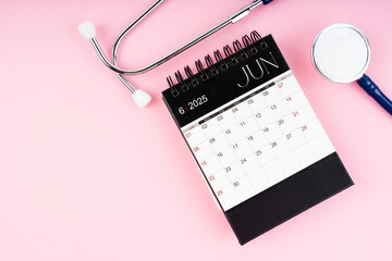 June 2025 calendar and stethoscope, Medical appointment schedule to check up.