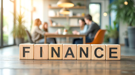 wooden blocks forming the word finance on a table in a blurred business setting