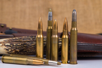 Bullets and hunting knife. Selective focus.
