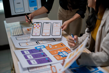 A woman is holding a piece of paper with a design on it