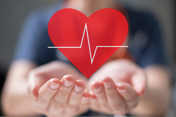 Professional healthcare medical worker holding red heart with cardiogram cardiologist concept