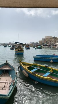 Fishers boats floating moored in Marsaxlokk fishing village on Malta