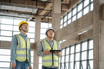 two asian male engineer working in construction site