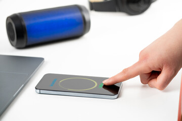 Business woman enjoys her tunes while scrolling through her smartphone.Black speaker creating the perfect atmosphere for relaxation and entertainment.Technologies in AI artificial intelligence systems