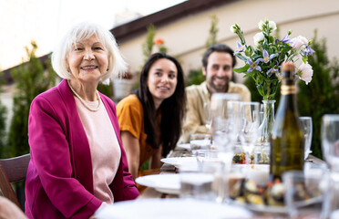 Family and friends celebrating at dinner on a rooftop terrace