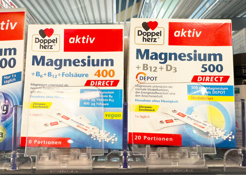 Magnesium supplements display in german pharmacy with vitamin b and d additives