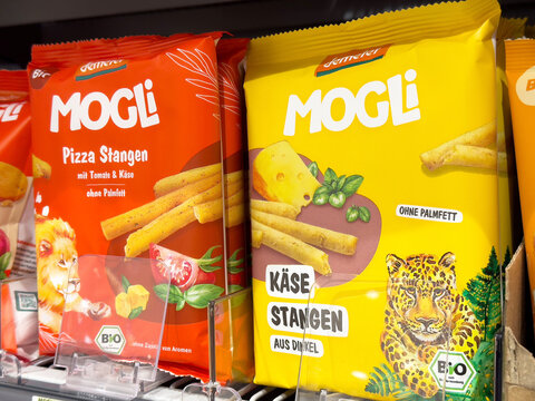 Organic mogli snacks display with tomato cheese and spelt flavors
