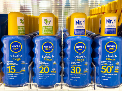 Assorted nivea sun spf bottles on store shelf with water resistant features