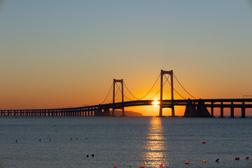 Sunrise Over Xinghai Bay Bridge: A Golden Morning