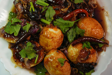 A favorite food for Thai people is Kai Luk Khoi, which is made by frying boiled eggs and sprinkling them with caramel.