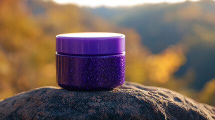 blank violet porcelain cosmetic jar on a rock