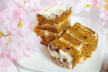 Easter-themed photo with a sweet pie, eggs, and pink flowers in soft tones, creating a delicate and charming spring atmosphere.