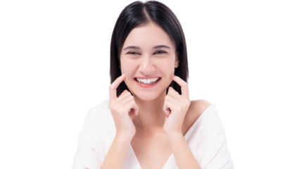 Cheerful young woman with bright smile pointing to cheeks, expressing happiness and confidence. Happy girl get Thooth Whitening  Beautiful woman has beautiful tooth, white teeth, nice tooth alignment.
