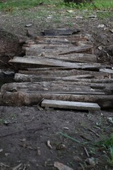 Rustic Log Bridge Crossing a Muddy Creek Bed