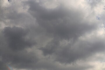 Dramatic Cloudscape with Ominous Dark Clouds and a Hint of Rainbow