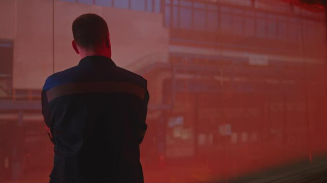 A man in a fireproof suit stands in the smelting shop of a metallurgical plant.