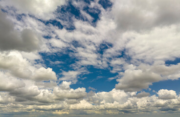 Fototapeta premium Blue sky with white summer rain clouds. Colorful summer landscape