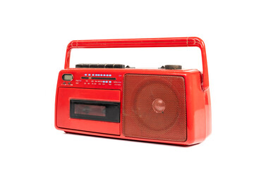 Old fashioned red cassette radio isolated on white background.
