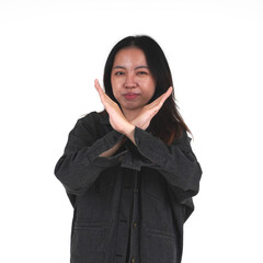 Asian woman wearing black denim jacket refusing with crossed hands gesture pose isolated on white...