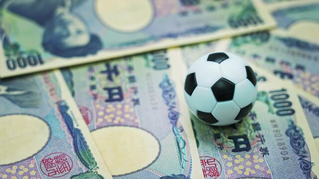 Soccer ball on stack of yen