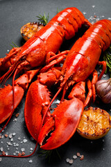 Steamed red lobsters with lemon, ready to eat. Side view. Close-up.