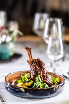 Leg of lamb on mashed potatoes with kale, demi-glace and herbs