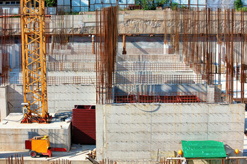 Construction site bustling with activity under a bright sun in an urban environment