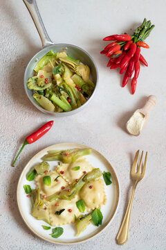 Ravioli with Robiola pecorino, mint, artichokes and chicory and pink pepper