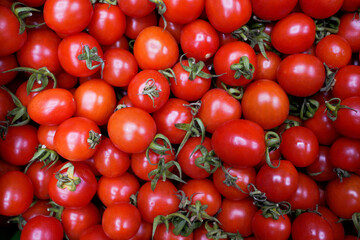 Red tomatoes background. Top view. Tomato texture. Selective focus.