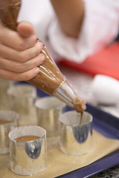 Pour chocolate mousse into dessert rings