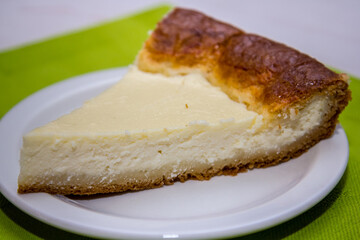 Cheesecake in a white plate on a green napkin