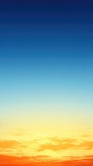 Fototapeta premium Vibrant Sunset Sky with Gradient Colors from Deep Blue to Warm Yellow Horizon