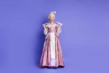 Fototapeta premium Elegant woman in baroque style dress surrounded by purple background, depicting royalty and historical sophistication.