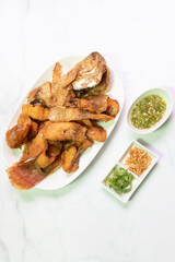 Deliciously fried Ruby fish served with spicy sauce.