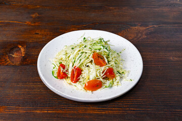 Fresh summer salad with cabbage, cucumber, and tomatoes