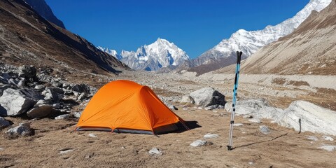 The Stunning Mountain Landscape features a Bright Orange Tent set against a High Altitude backdrop
