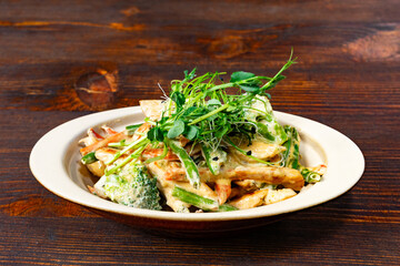 Mixed vegetable pasta with creamy sauce served in a bowl