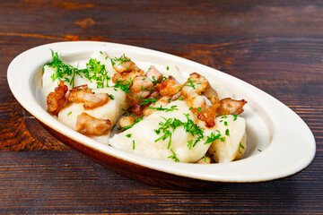 Delicious dumplings topped with crispy meat and herbs