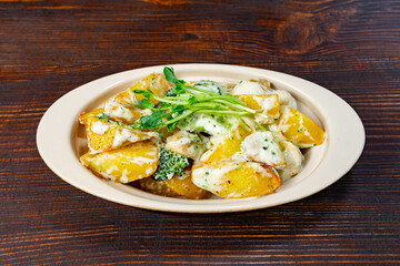 Delicious roasted potatoes with creamy sauce and broccoli garnish